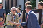 Bill Shideler and Randy Head shake hands at Cass County Memorial Day Parade.