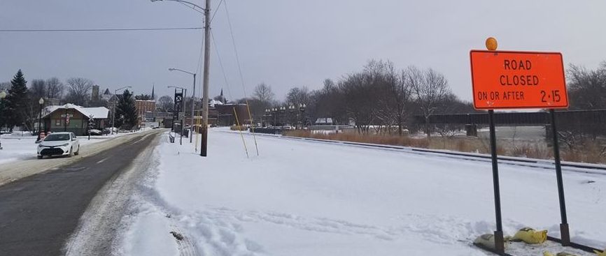 White car traveling on snowy road in Logansport, IN