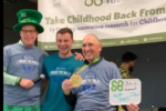 Three men smiling at fundraiser